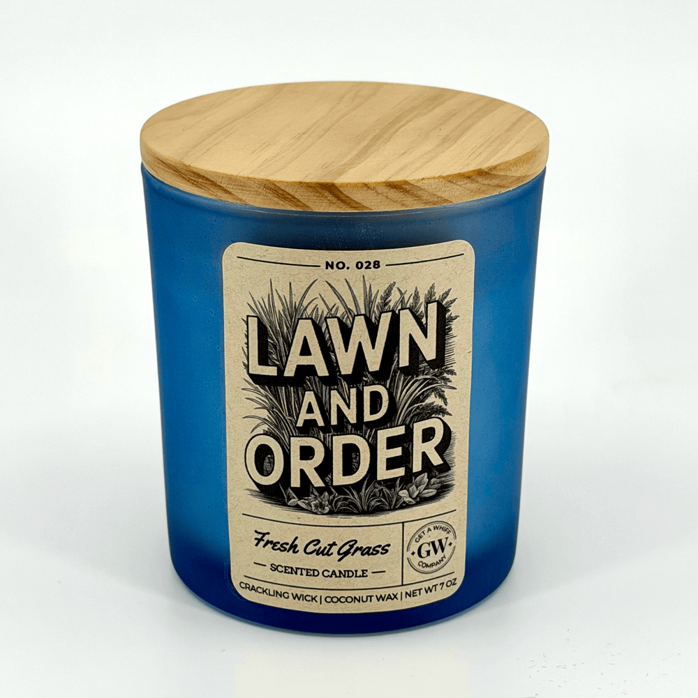 Blue candle with wooden lid labeled 'Lawn and Order' on a white background