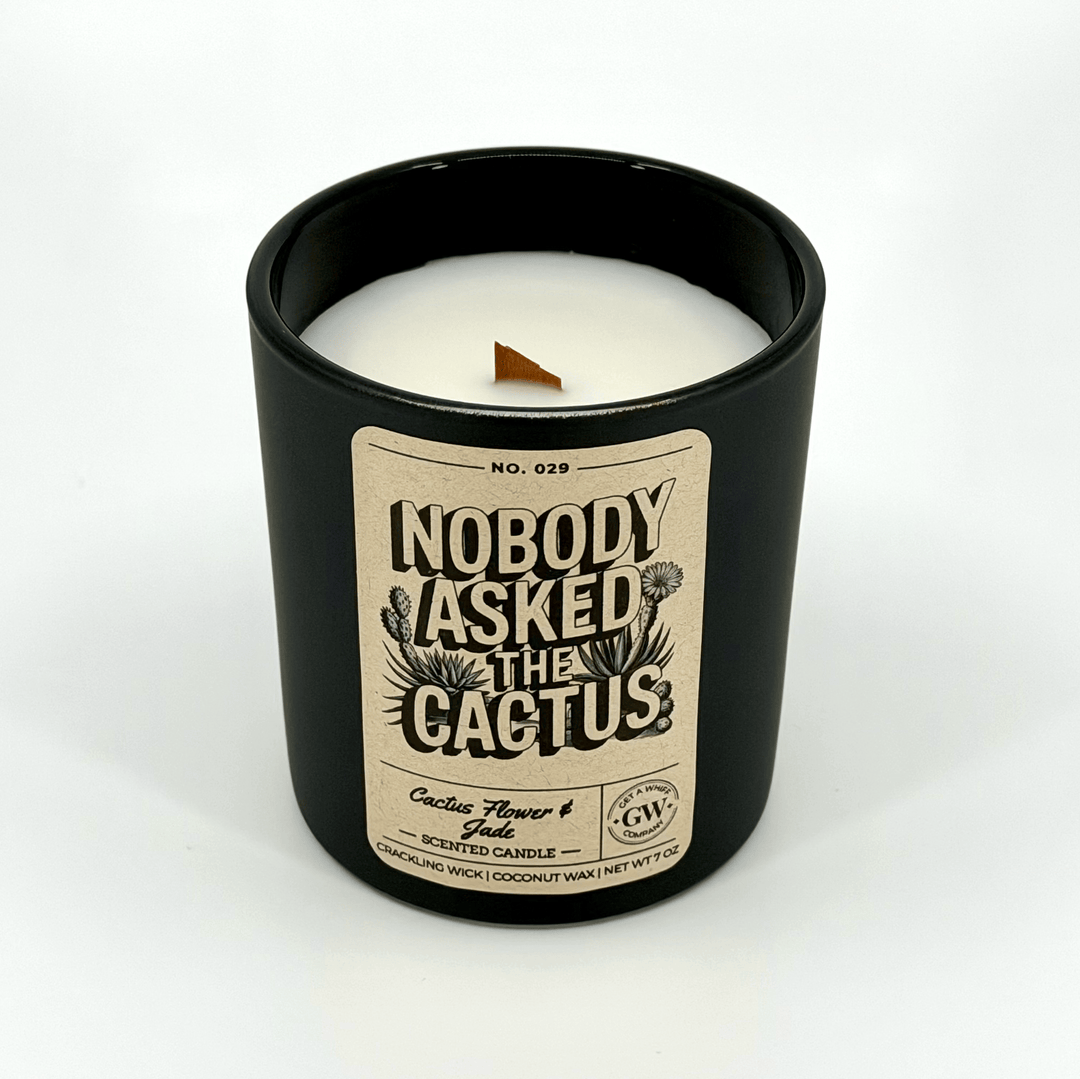 Candle in a black container with a label on a white background