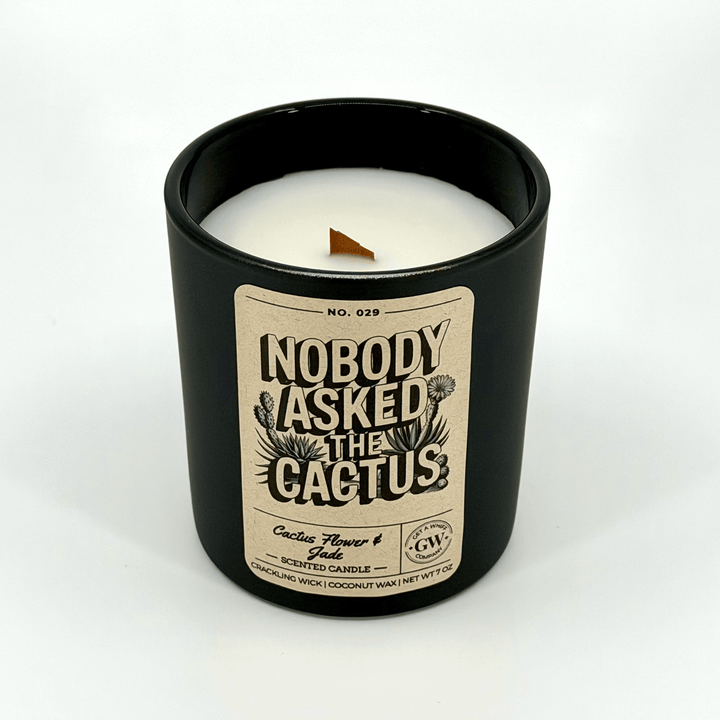 Candle in a black container with a label on a white background