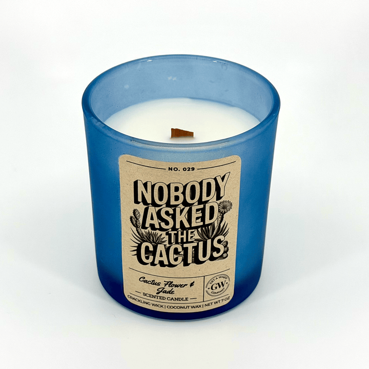 Blue candle with a label reading &