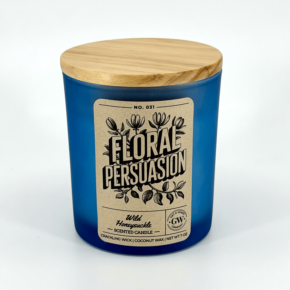 Blue candle with wooden lid and 'Floral Persuasion' label on a white background