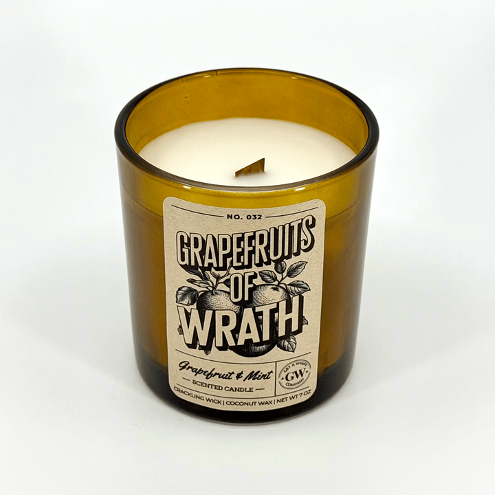 Grapefruits of Wrath candle in a amber glass bottle on a white background