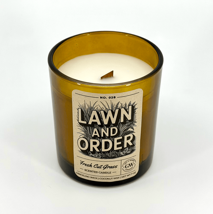 Candle in a glass jar labeled &