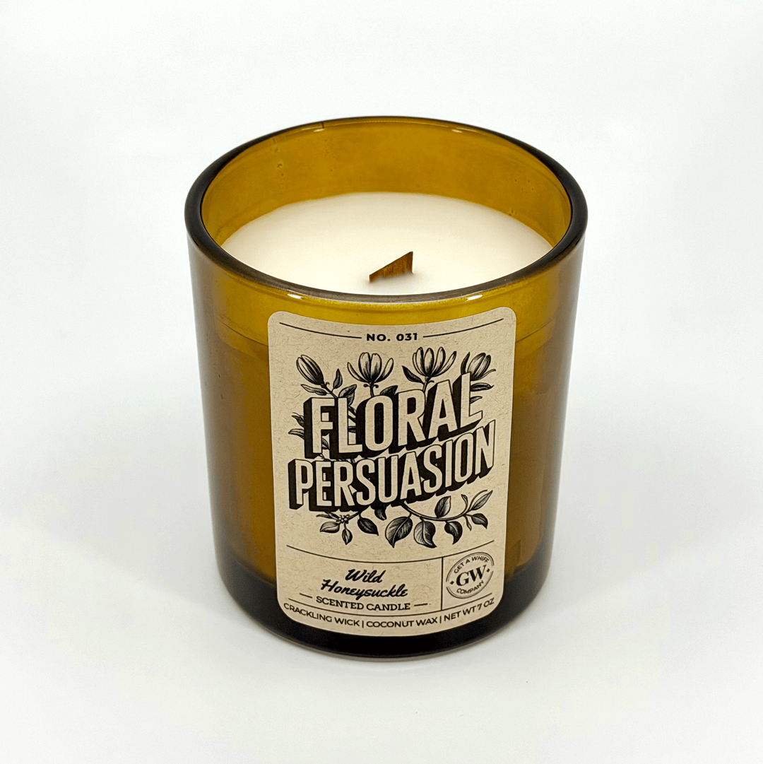 Candle in a glass bottle labeled &