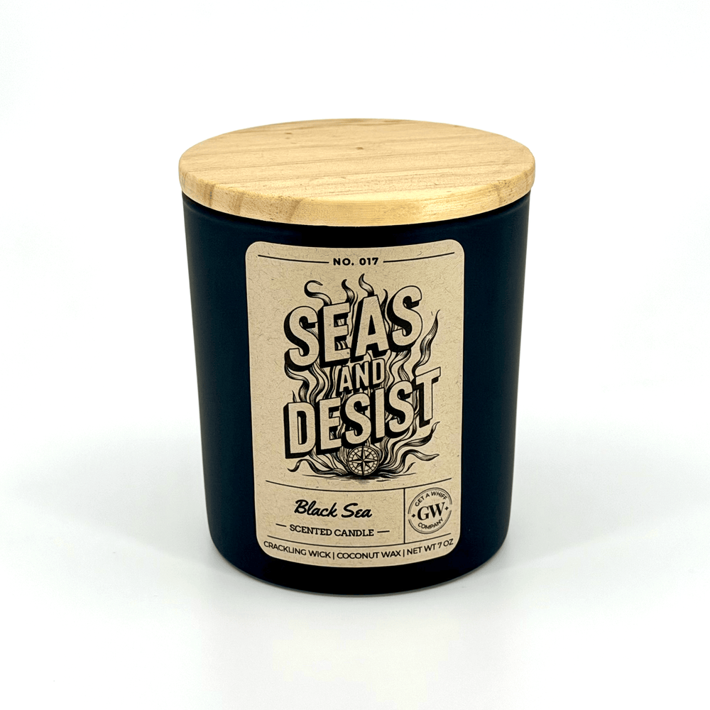 Black candle with wooden lid and label on a white background