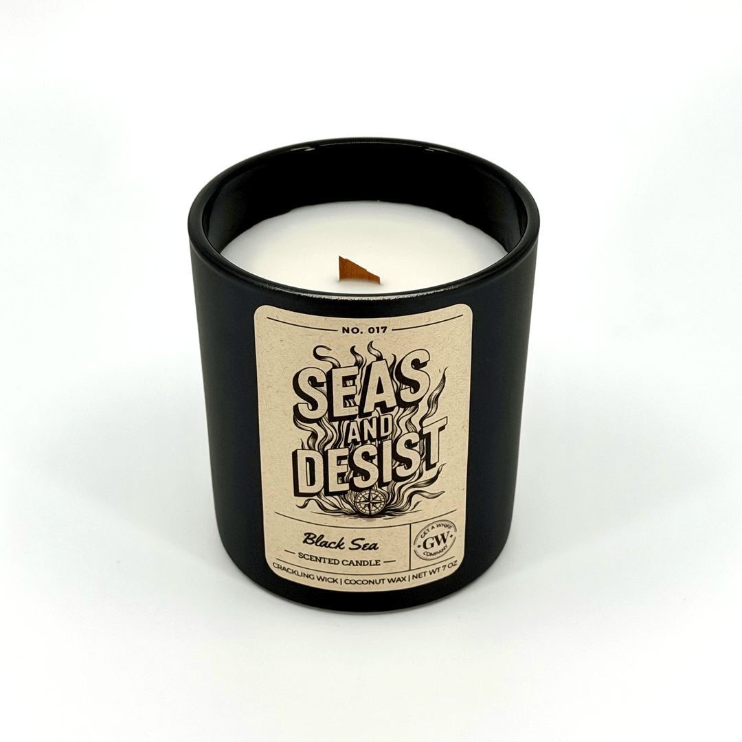 Candle in a black container with a label on a white background