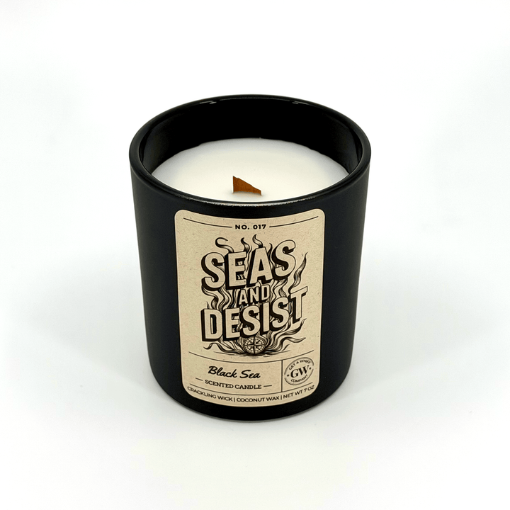 Candle in a black container with a label on a white background