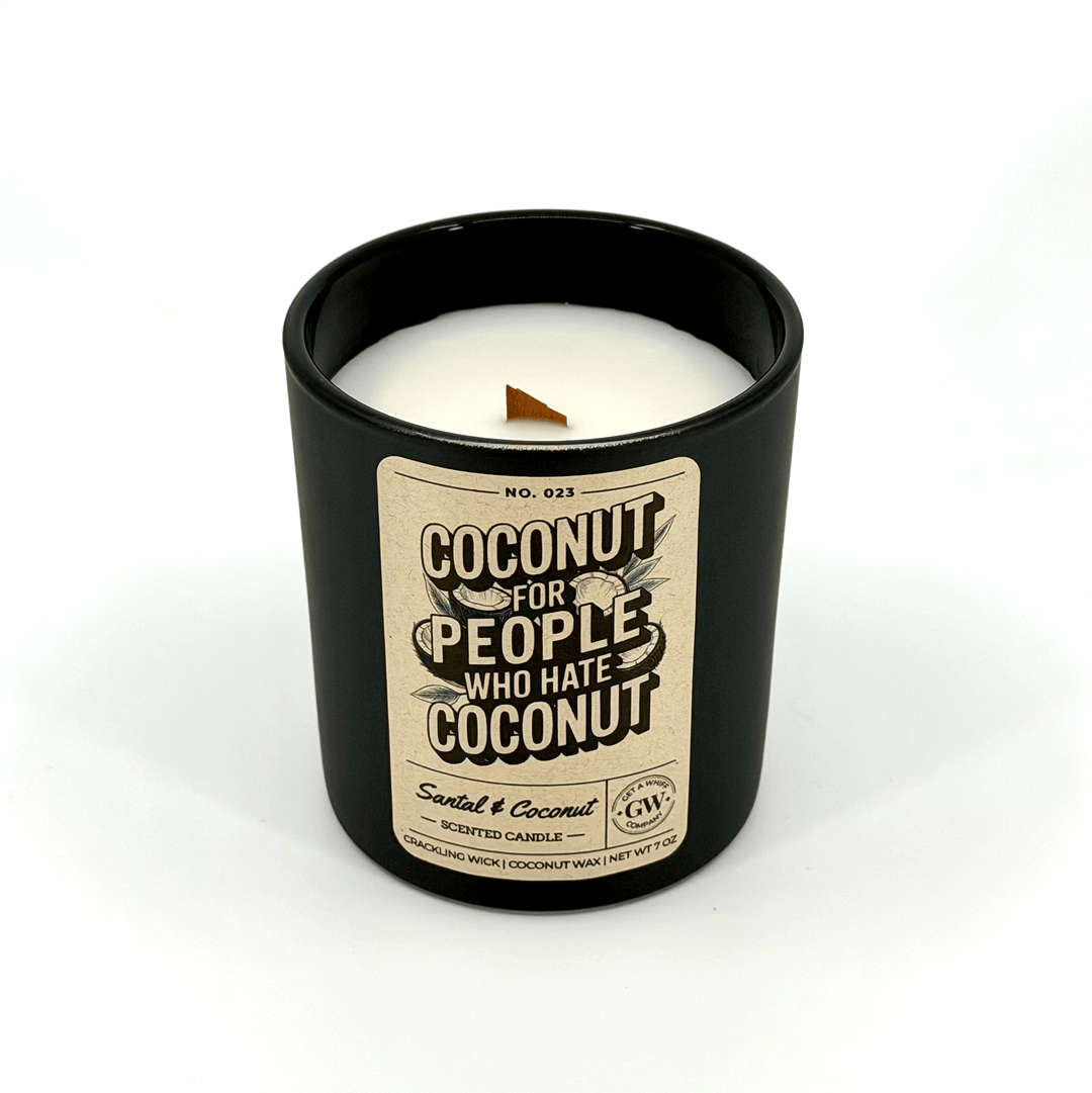 Candle in a black container with a label on a white background