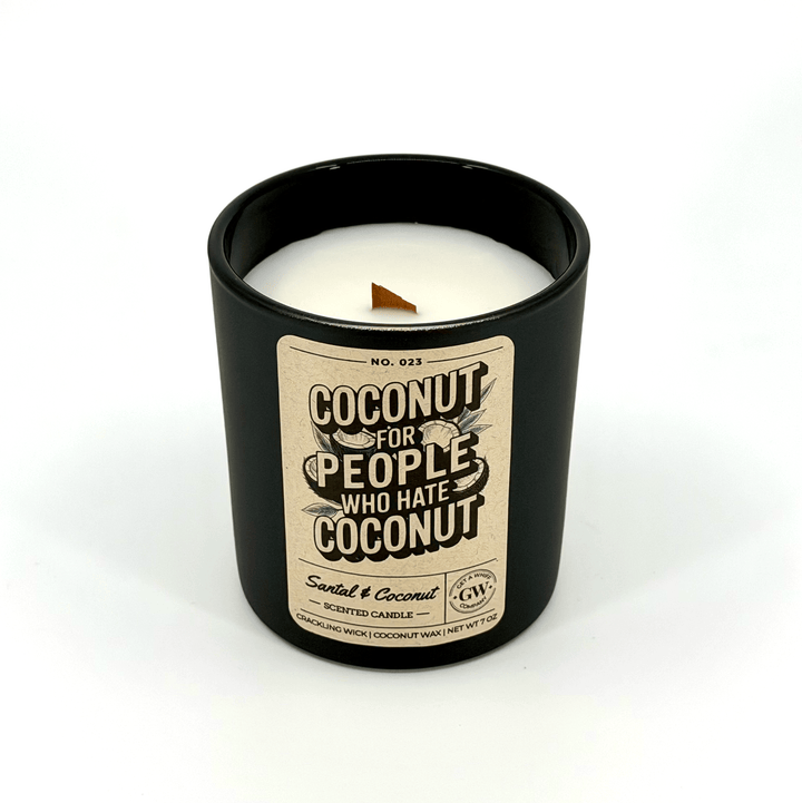 Candle in a black container with a label on a white background