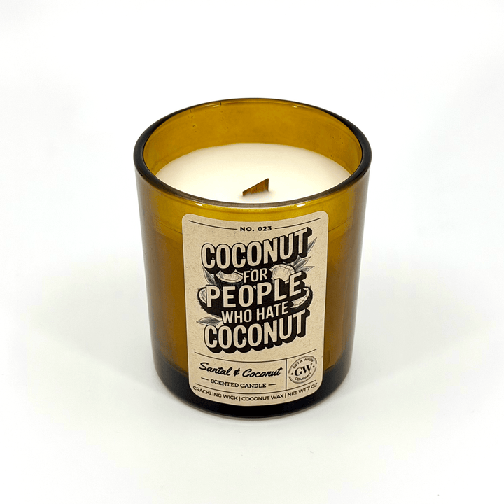 Candle in a glass bottle with a label on a white background