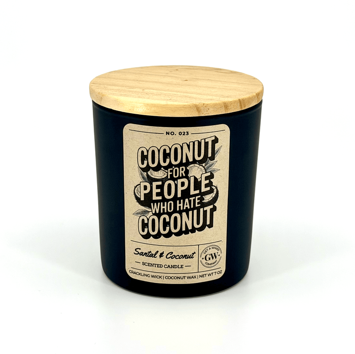 Candle with a wooden lid and humorous label on a white background