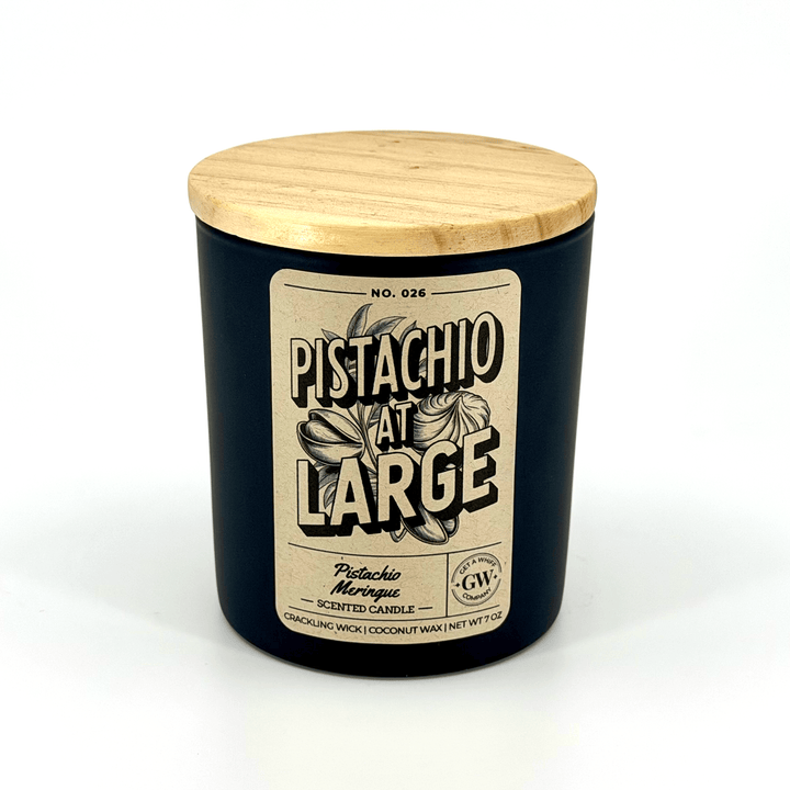 Pistachio scented candle with a wooden lid on a white background