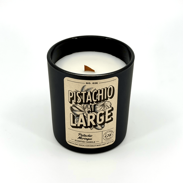 Candle in a black container with a label on a white background
