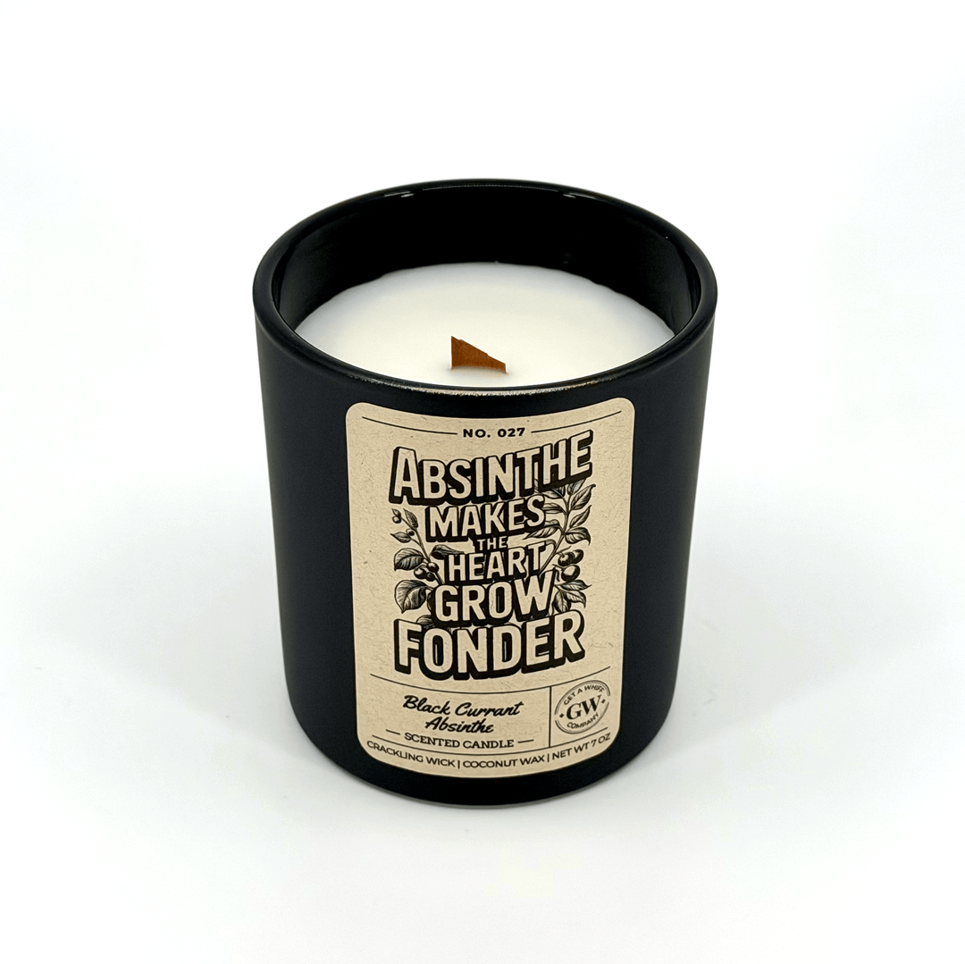 Black candle with a decorative label on a white background