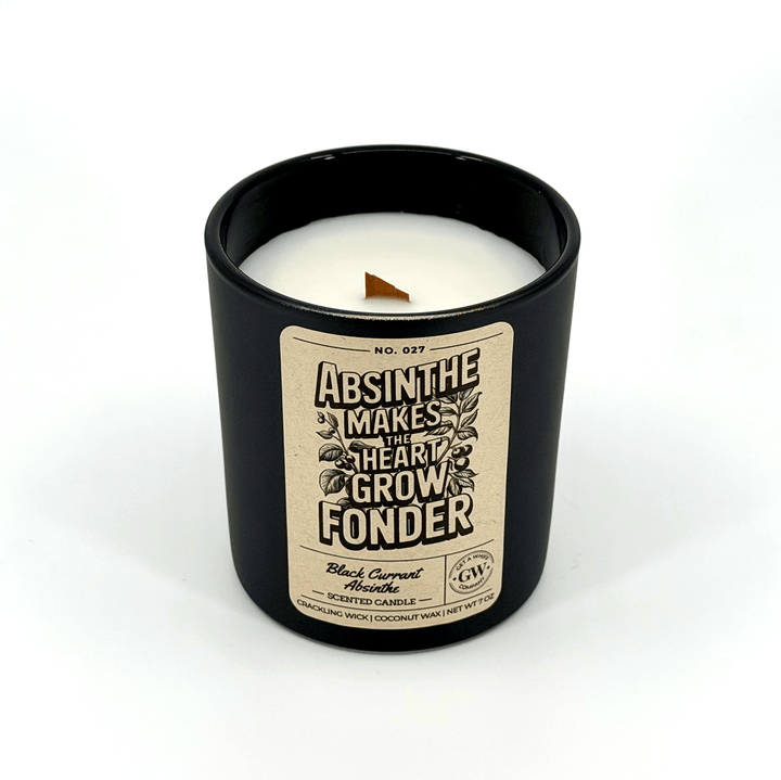 Black candle with a decorative label on a white background