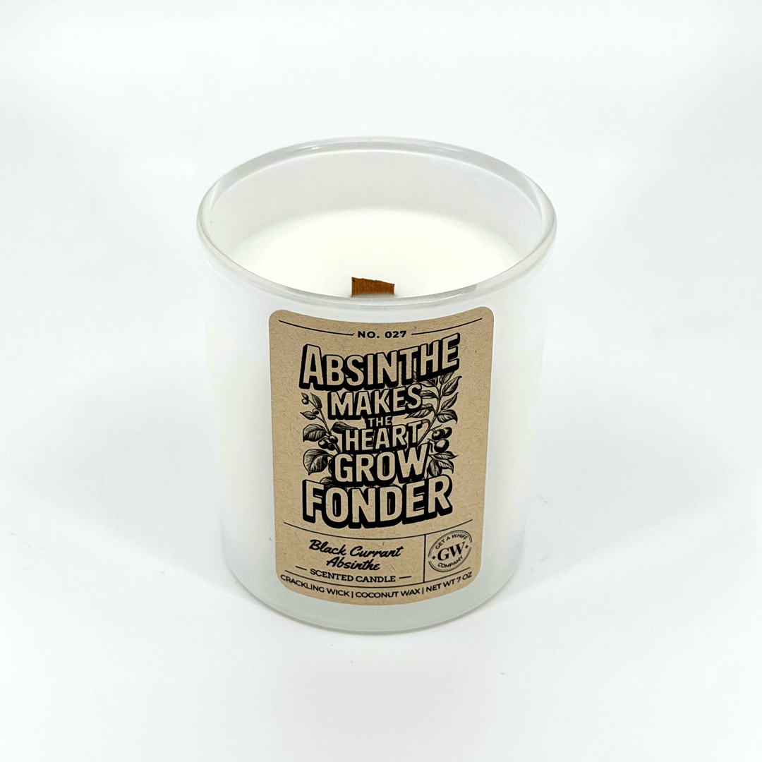 Candle in a clear container with a label on a white background