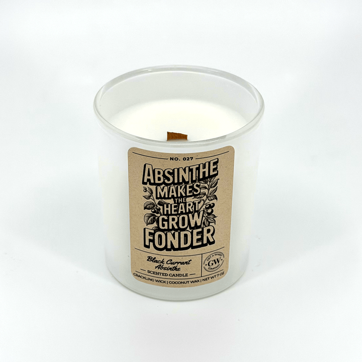 Candle in a clear container with a label on a white background