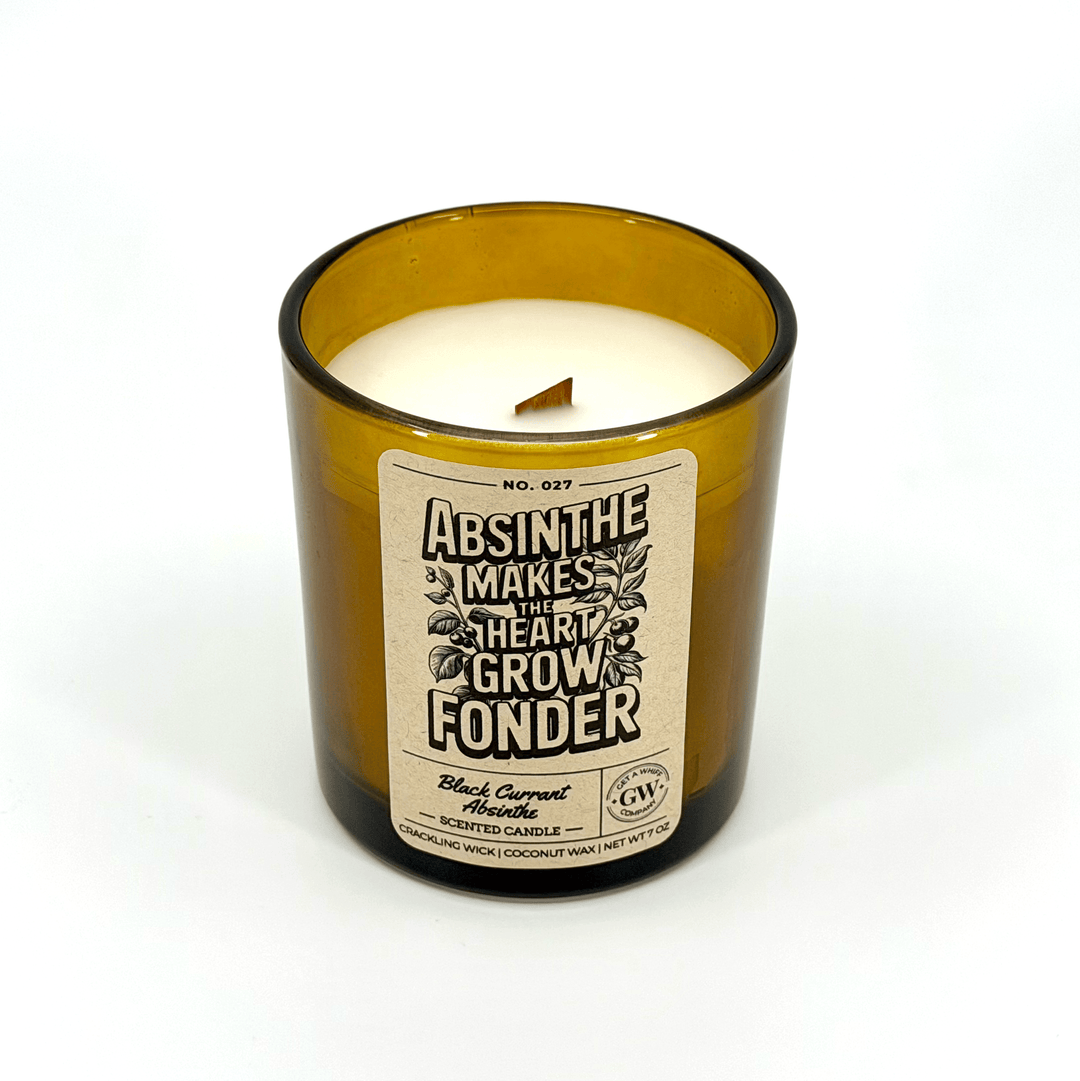 Candle in an amber glass bottle with a label on a white background