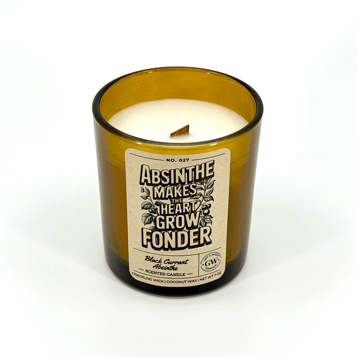 Candle in an amber glass bottle with a label on a white background