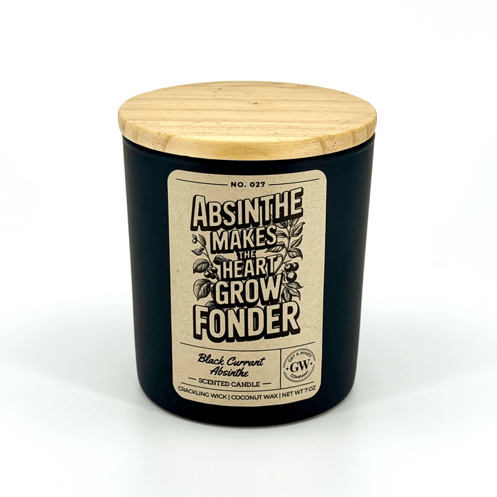 Black candle with wooden lid and decorative label on a white background