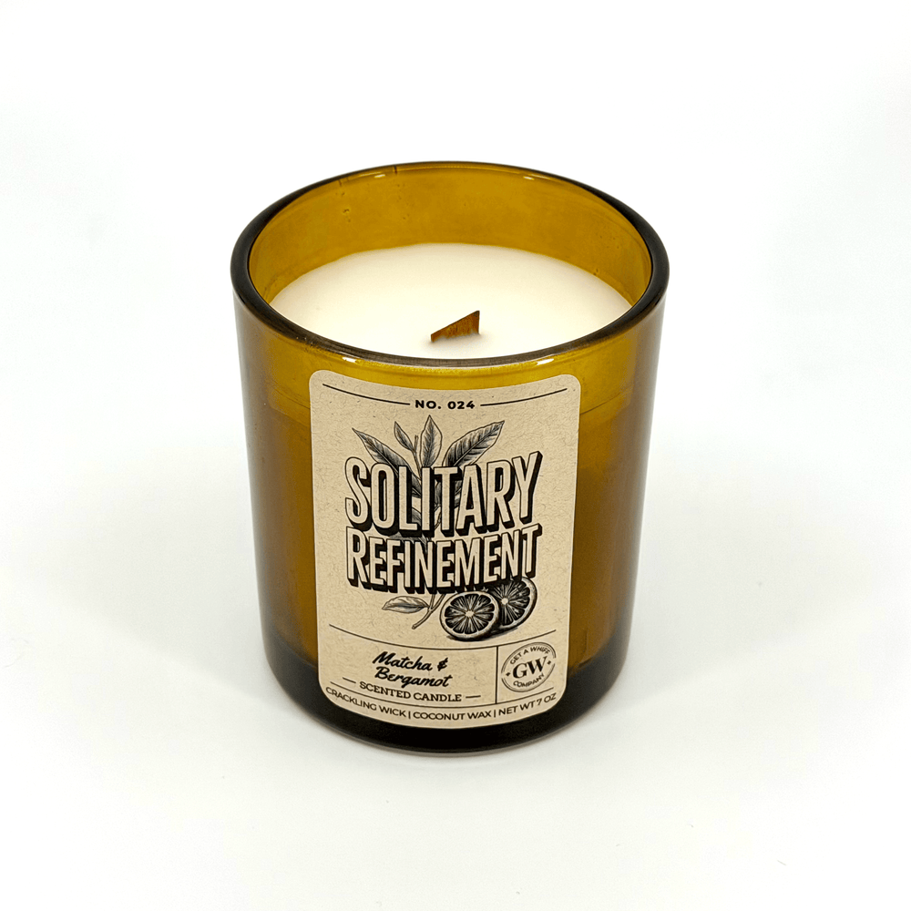 Candle in a bottle with a label on a white background