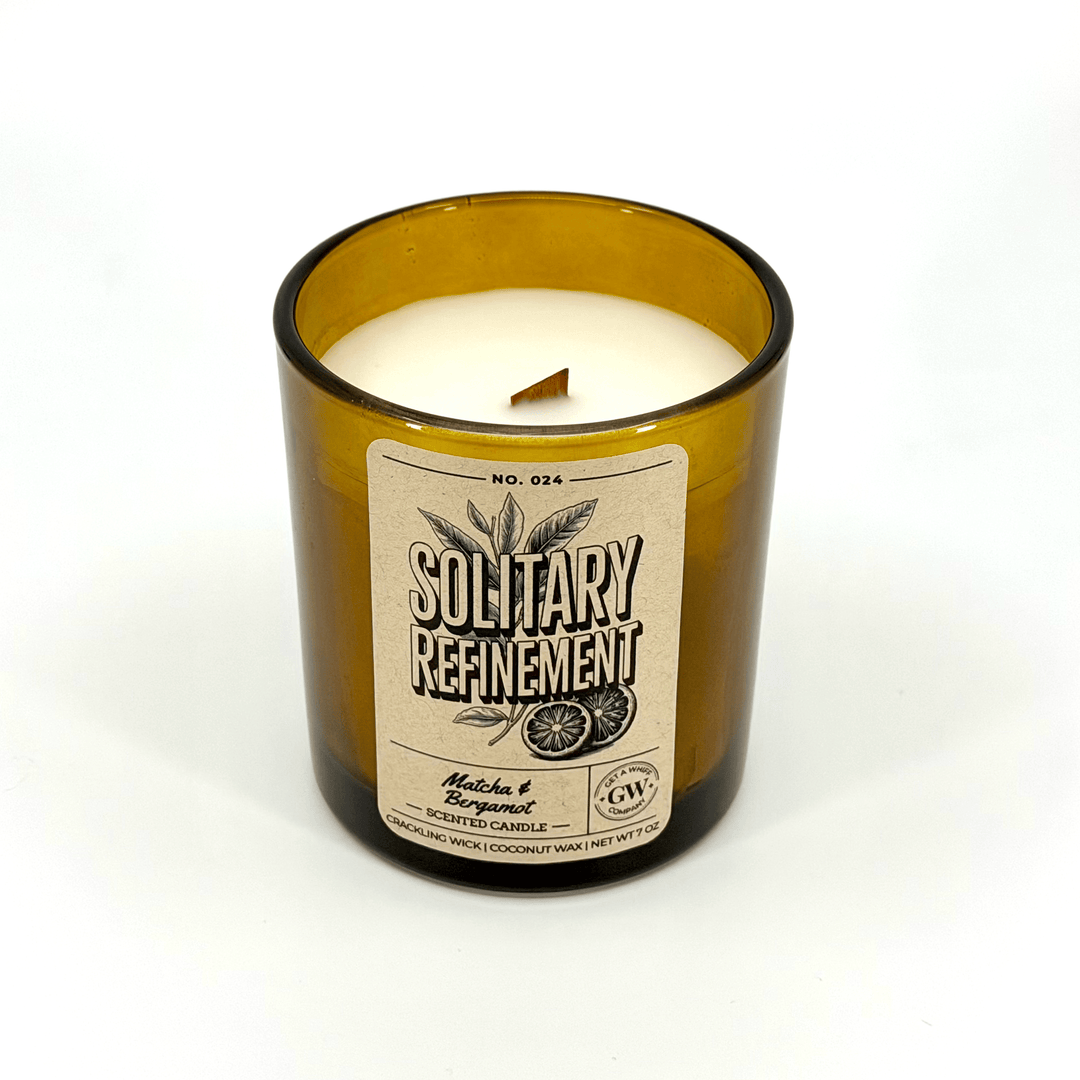 Candle in a bottle with a label on a white background