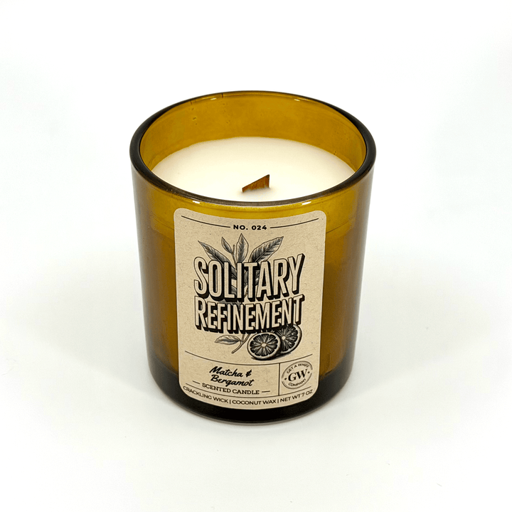 Candle in a bottle with a label on a white background