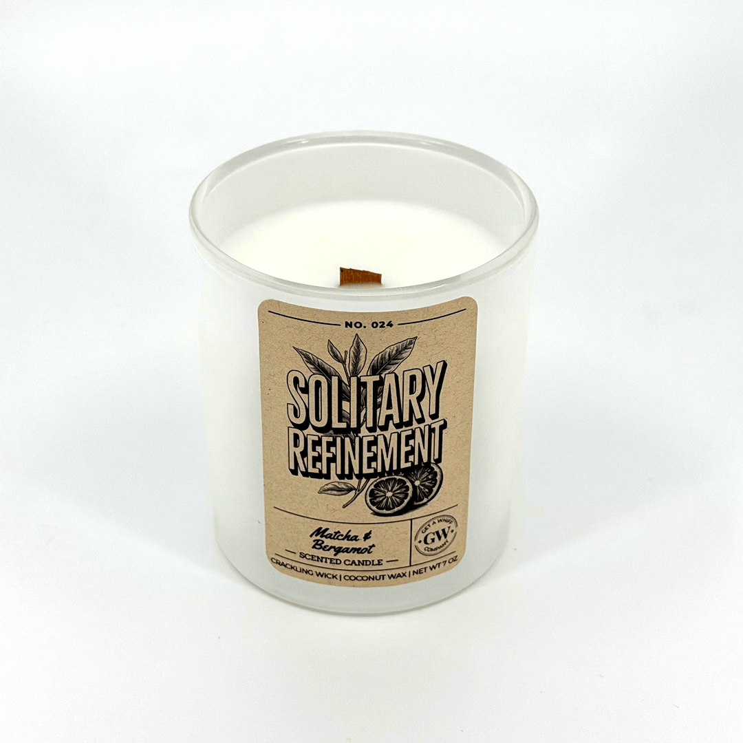 Candle in a glass jar with a label on a white background