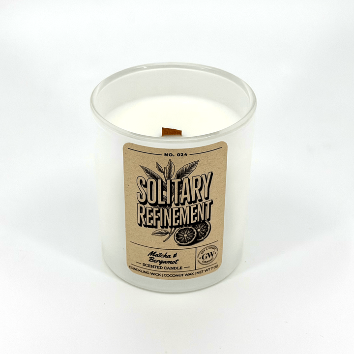Candle in a glass jar with a label on a white background