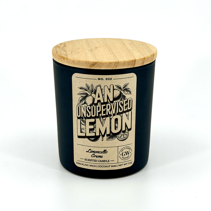 Black candle with wooden lid and label on a white background