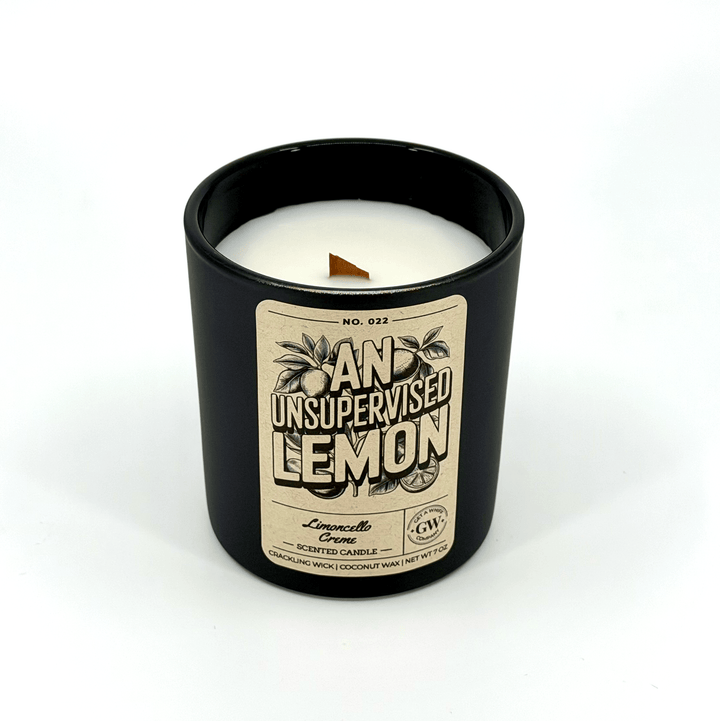 Black candle with a label on a white background