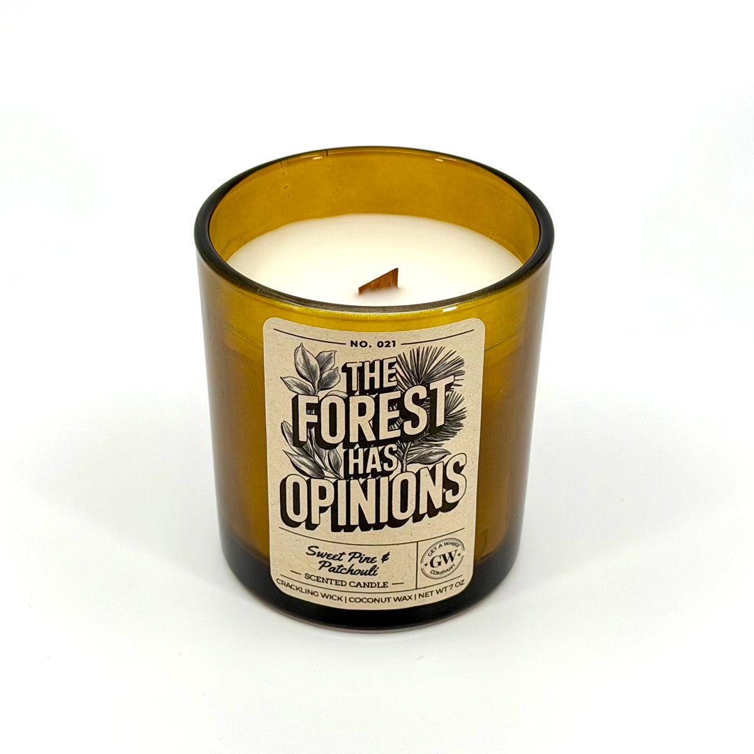 Candle in a brown glass jar with a label on a white background