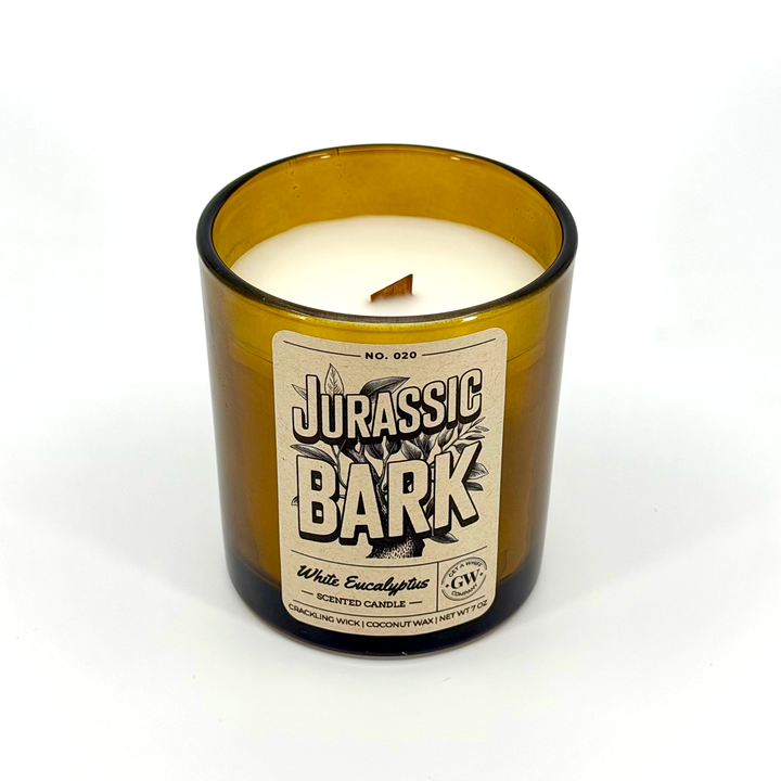 Candle in a glass jar labeled &