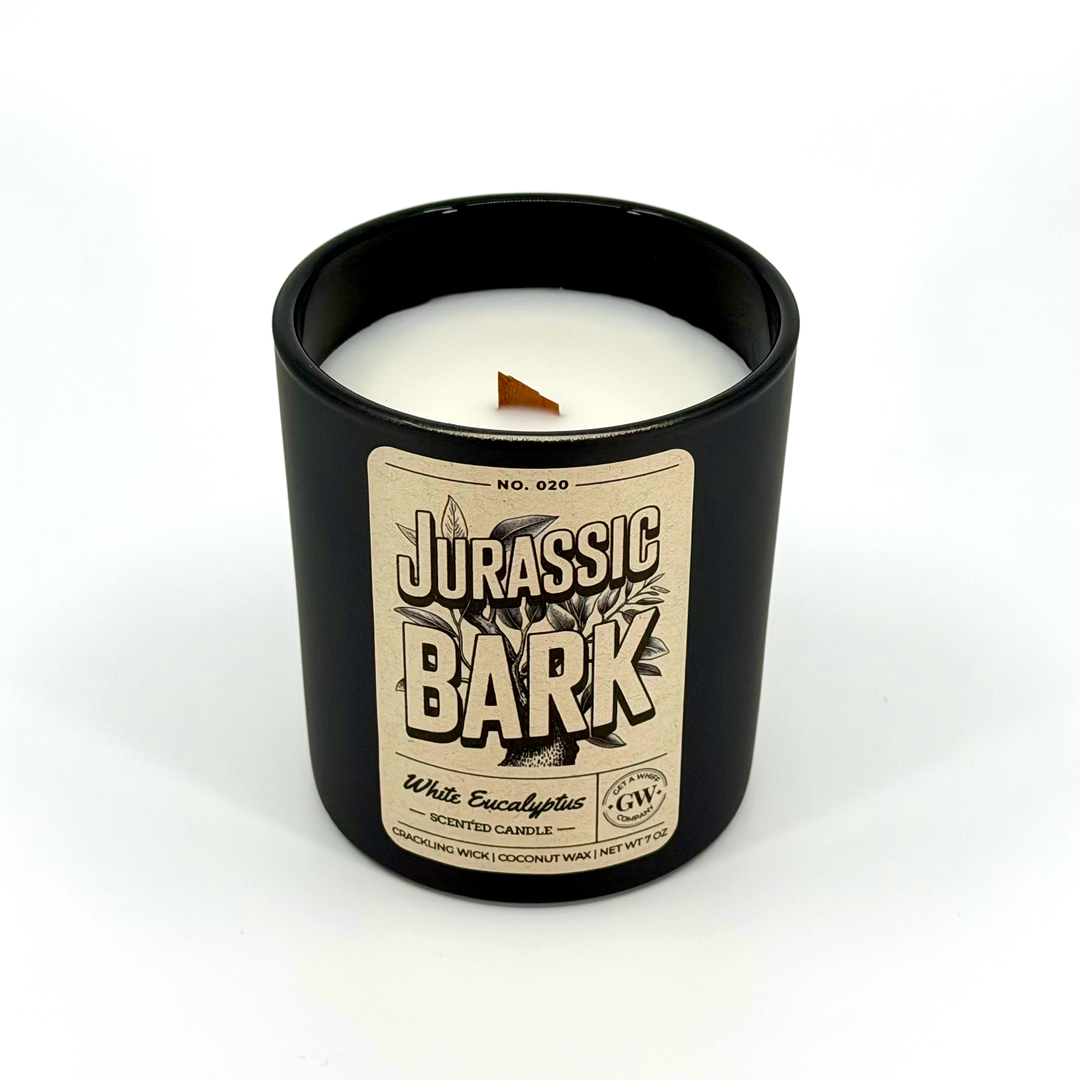 Candle in a black container with a 'Jurassic Bark' label on a white background