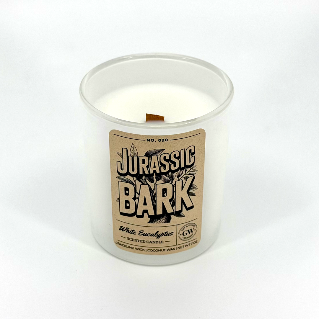 Candle in a white container with a &