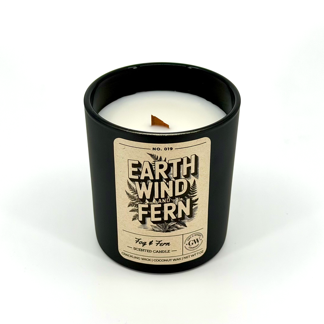 Black candle with a label on a white background