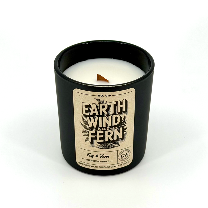Black candle with a label on a white background