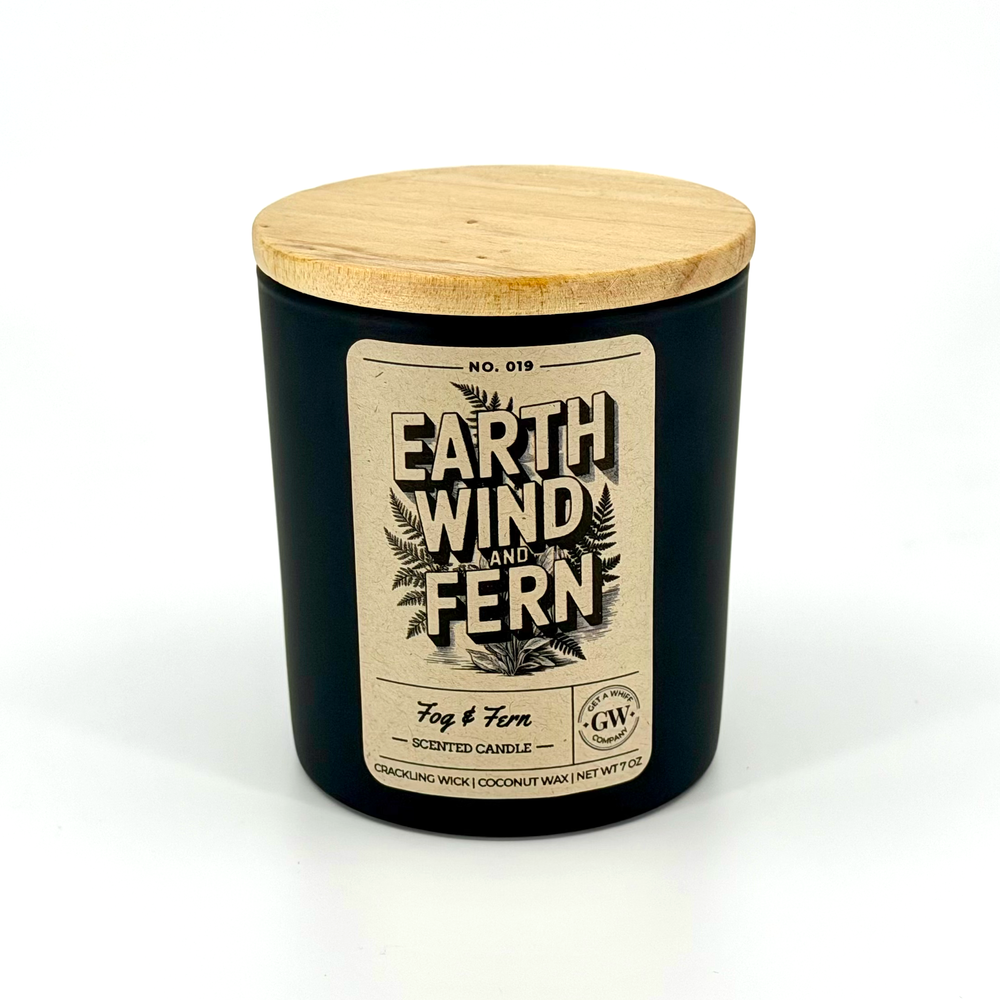 Black candle jar with wooden lid and label on a white background