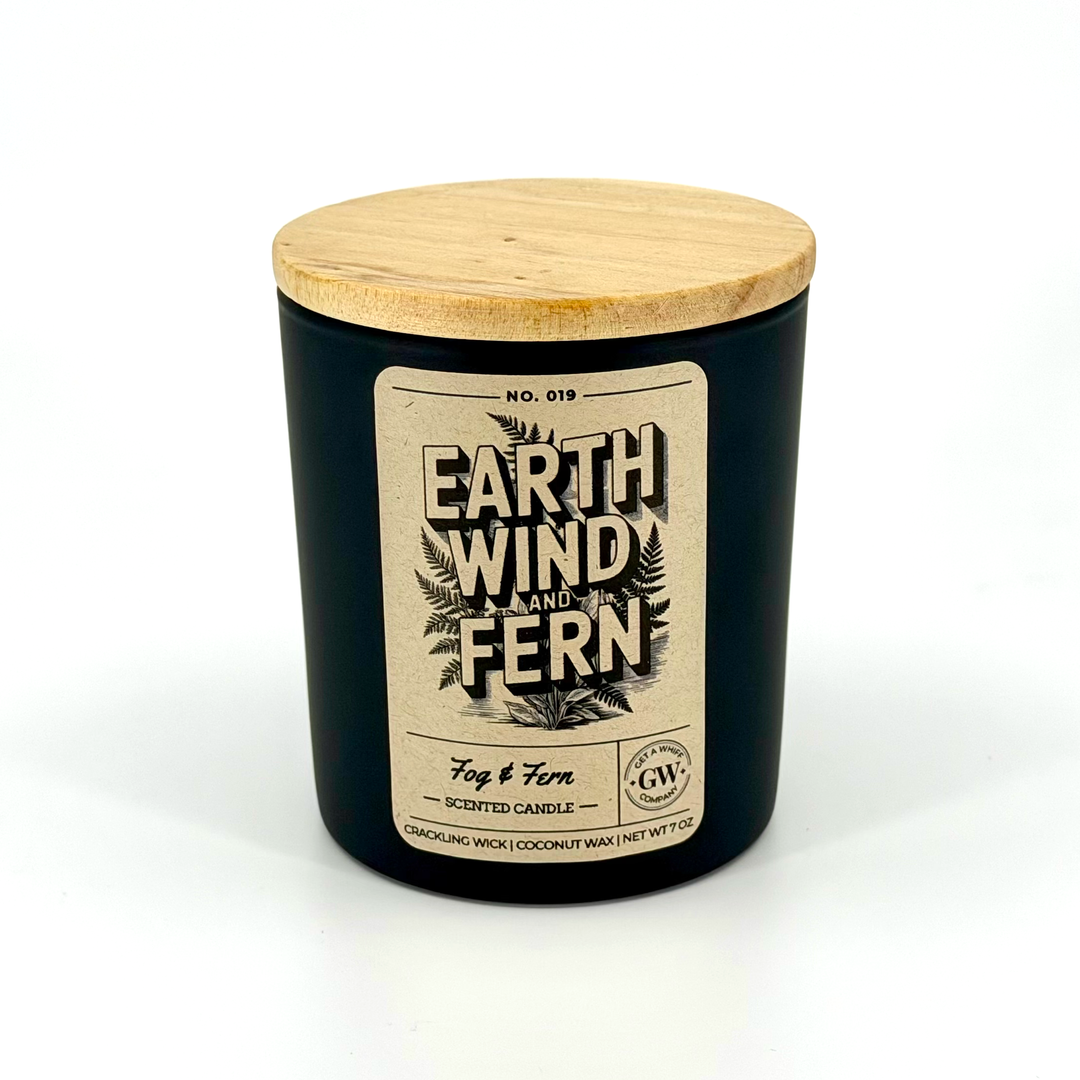 Black candle jar with wooden lid and label on a white background