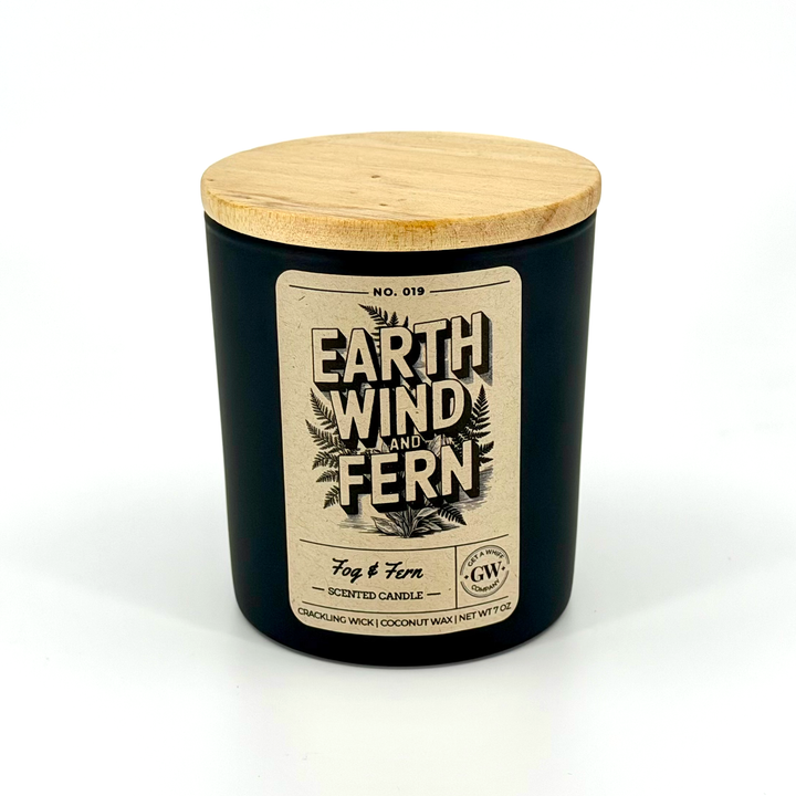 Black candle jar with wooden lid and label on a white background
