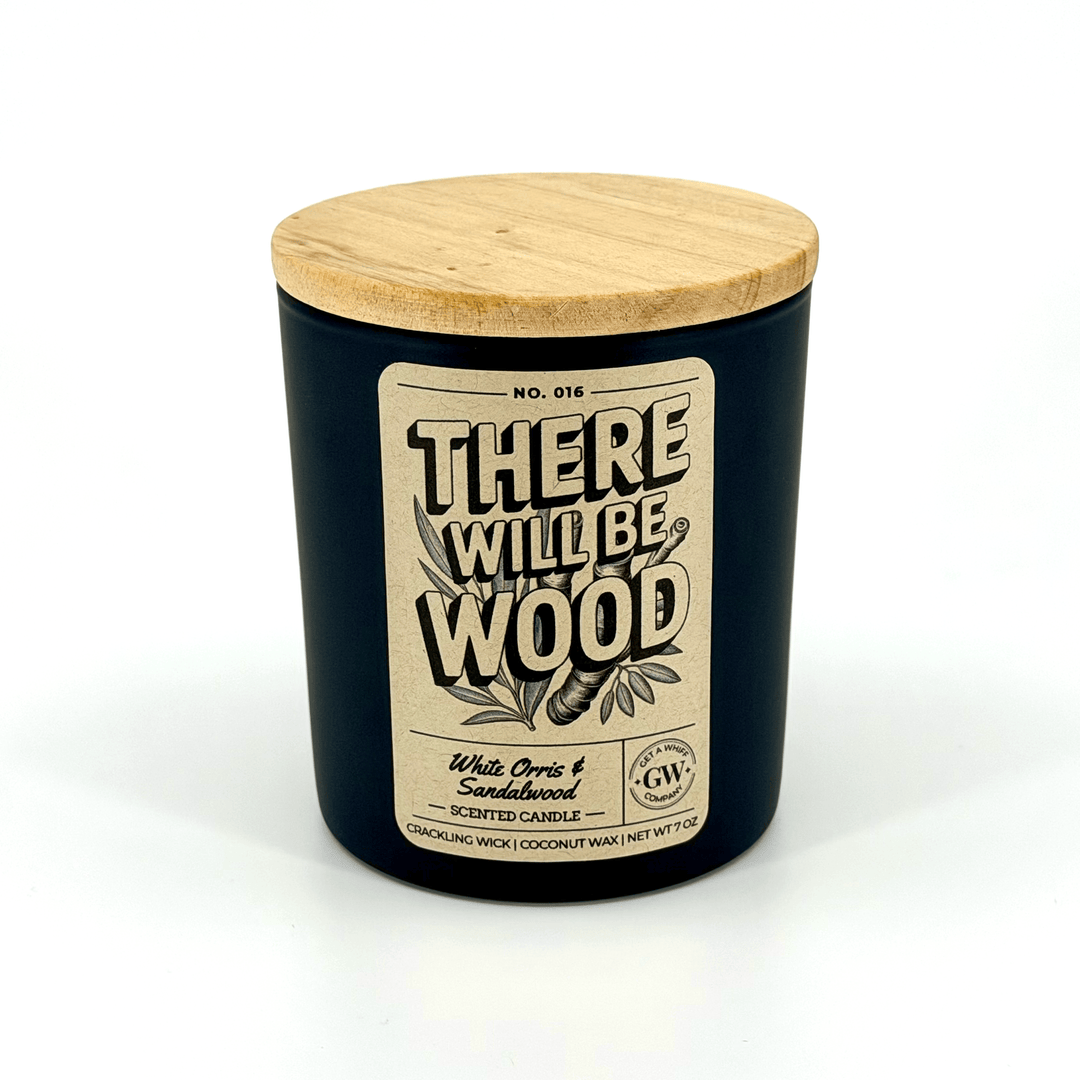 Black candle with wooden lid and label on a white background
