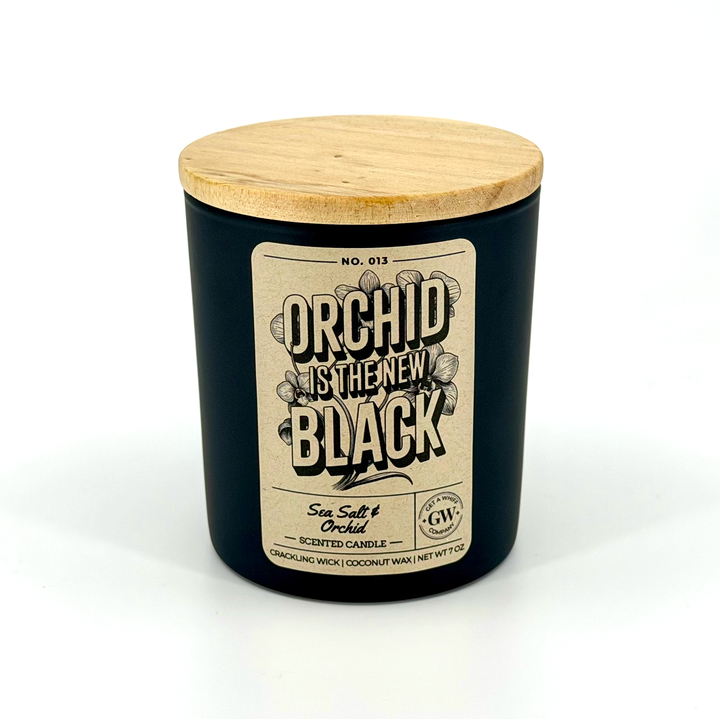 Candle with wooden lid and decorative label on a white background