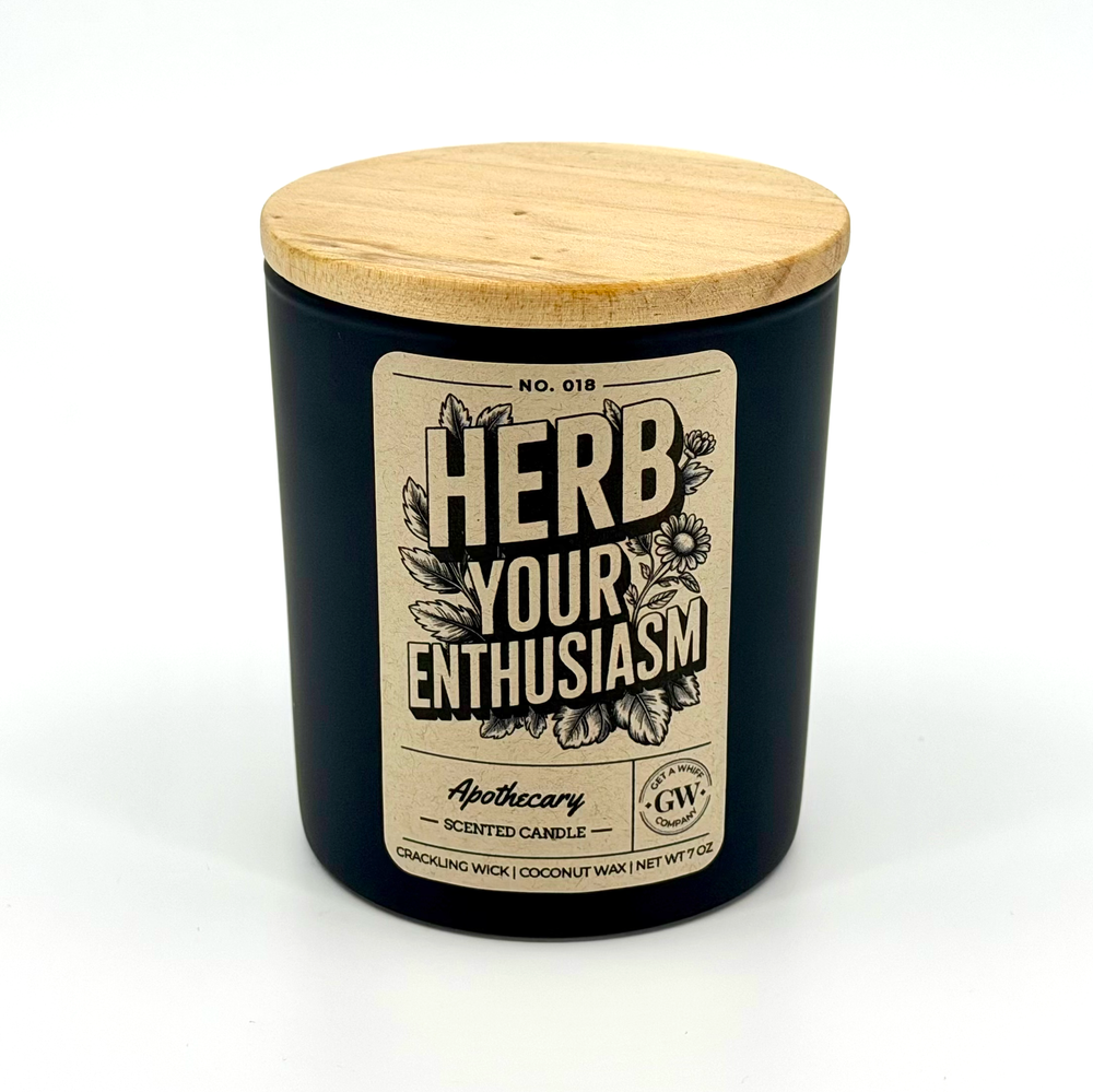 Black candle with wooden lid and 'Herb Your Enthusiasm' label on a white background