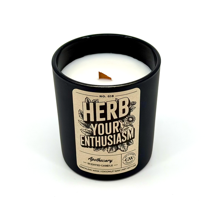 Candle in a black container with a label on a white background