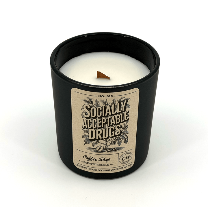 Candle in a black container with a label on a white background