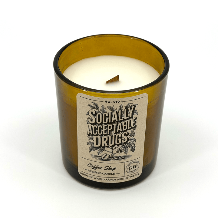 Candle in a glass bottle labeled &