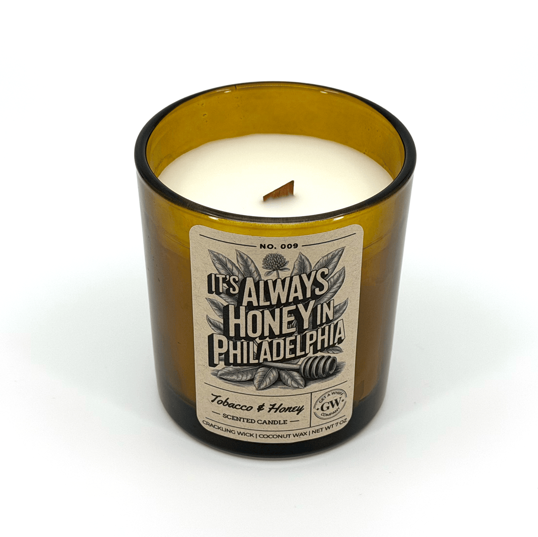 Candle in a glass container with a label on a white background