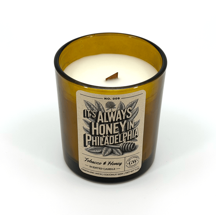 Candle in a glass container with a label on a white background