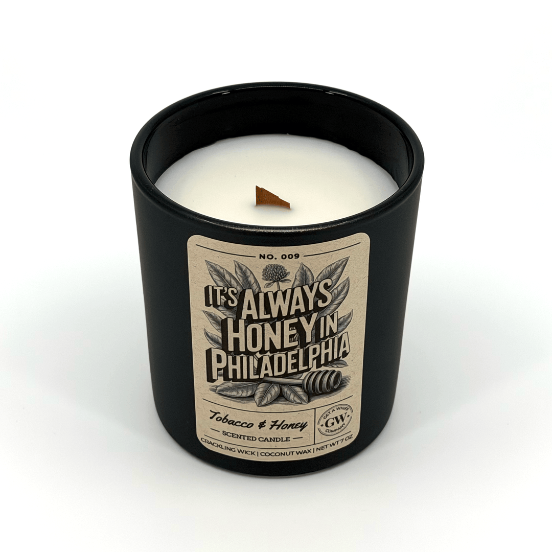 Candle in a black container with a label on a white background