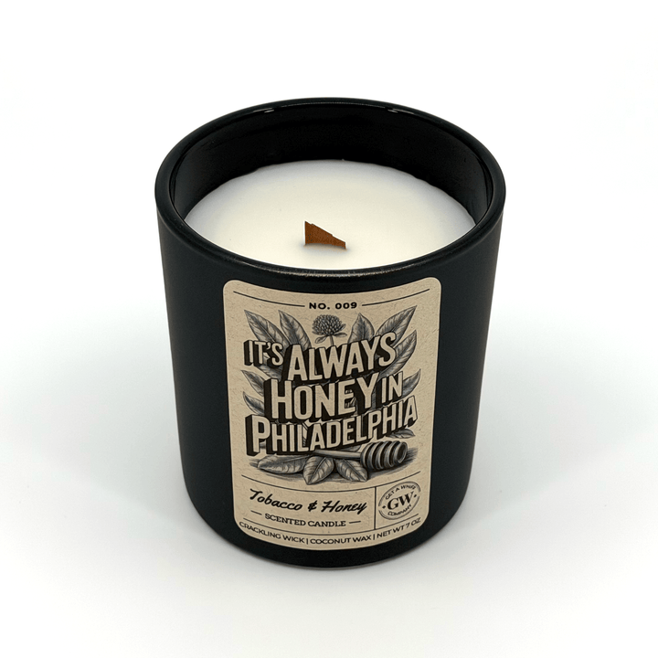 Candle in a black container with a label on a white background